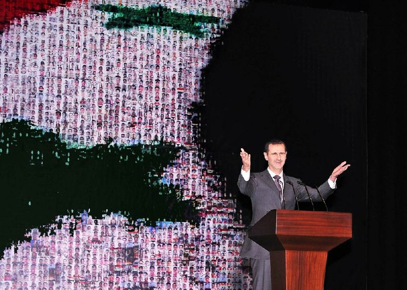 Syrian President Bashar Assad speaks at the Opera House in central Damascus on Sunday in this photo released by the Syrian official news agency SANA. It was Assad’s first public speech in six months. 