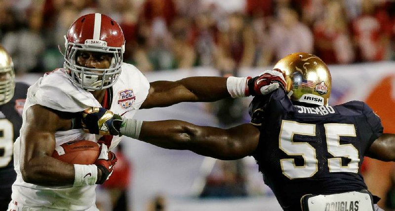 Alabama running back T.J. Yeldon works his way past Notre Dame linebacker Prince Shembo (55) during the first half of Alabama’s 42-14 victory in the BCS National Championship Game on Monday night. Yeldon rushed 21 times for 108 yards and one touchdown. Yeldon and Lacy had a combined 41 rushes for 248 yards. “All Alabama,” Notre Dame Coach Brian Kelly said at halftime. “I mean we can’t tackle them right now. And who knows why? They’re big and physical — I guess I do know why.” 