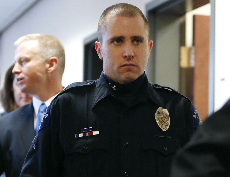 Aurora police officer Justin Grizzle leaves court after testifying at a preliminary hearing for James Holmes at the courthouse in Centennial, Colo., on Monday. Grizzle fought to keep his composure during his testimony, in which he described wounded people trying to run and crawl away from the theater.

