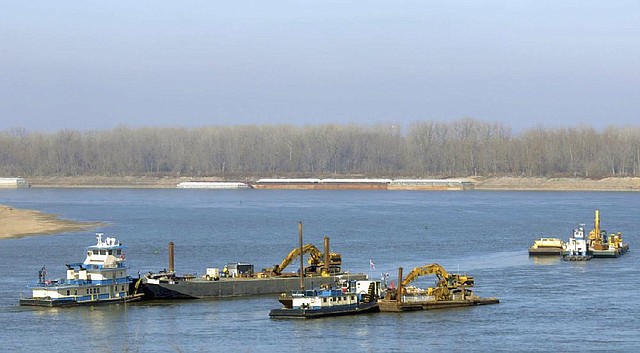 Boats from Newt Marine in Dubuque, Iowa, remove rocks from the bottom of the Mississippi River on Monday near Thebes, Ill., to deepen the channel. 
