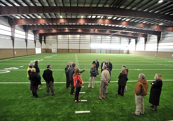 Fayetteville School District board members take a look around the new indoor practice facility at Fayetteville High School Monday afternoon. Board members were given a tour to see the progress of all the school’s facilities that are being built or renovated, including the Fahring Center, the indoor practice facility, the new tennis complex and the new track.
