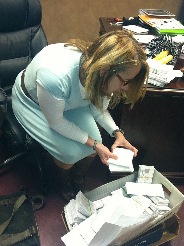 Mary Ley, communications director for the Bentonville School District, looks through survey results Tuesday.