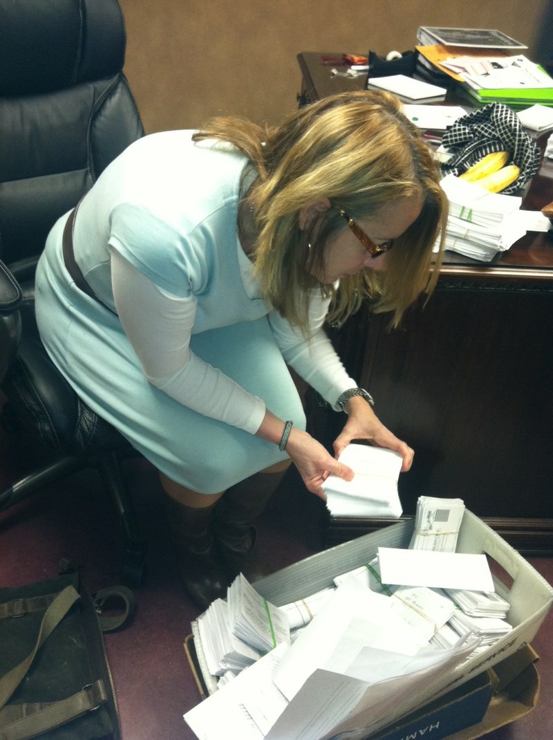 Mary Ley, communications director for the Bentonville School District, looks through survey results Tuesday.