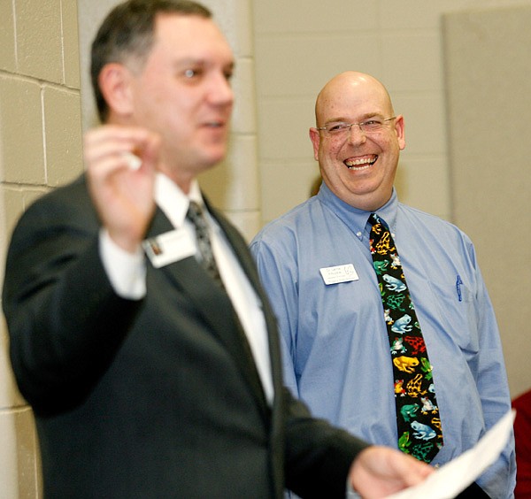 Lance Arbuckle, Rogers High School assistant principal, right, laughs while Richard Abernathy, executive director of Arkansas Association of Educational Administrators, speaks on Monday at the school. Arbuckle was recognized by the organization as the state’s assistant principal of the year. 
