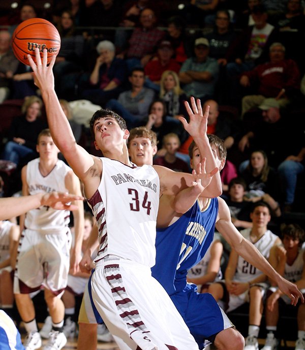 Siloam Springs junior Payton Henson stretches for a rebound against Harrison during the second half in Siloam Springs on Friday, Jan. 20, 2012. On Friday, Henson scored 39 points and grabbed 12 rebounds in the Panther's 69-62 victory against Springdale Har-Ber to earn 7A/6A-West Conference Player of the Week honors. 