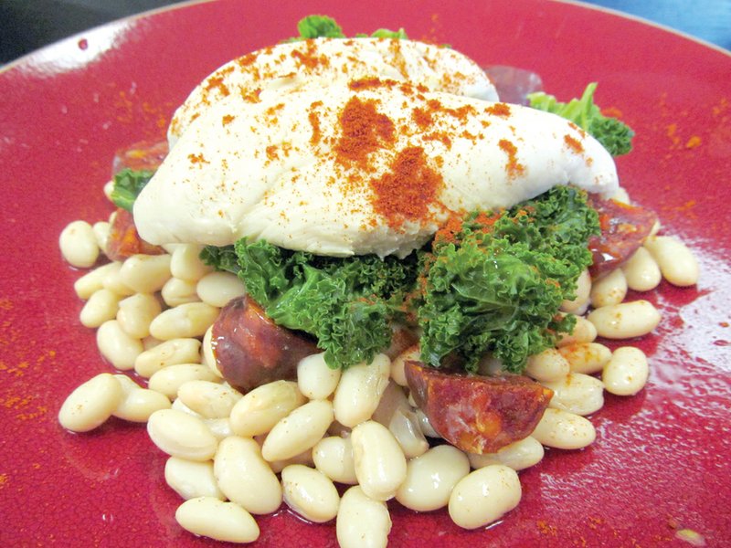 Tender poached chicken perched atop crisp, curly kale over cannellini beans flavored with chorizo sausage bites and finished with smoked, sweet paprika combines several of the food trends expected to be hot in 2013.