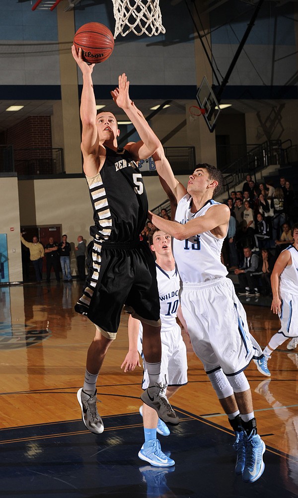 Nick Smith, a Bentonville senior, scores as Springdale Har-Ber junior Brandon Buccheri defends Tuesday during the first half of play at Har-Ber High School in Springdale. 