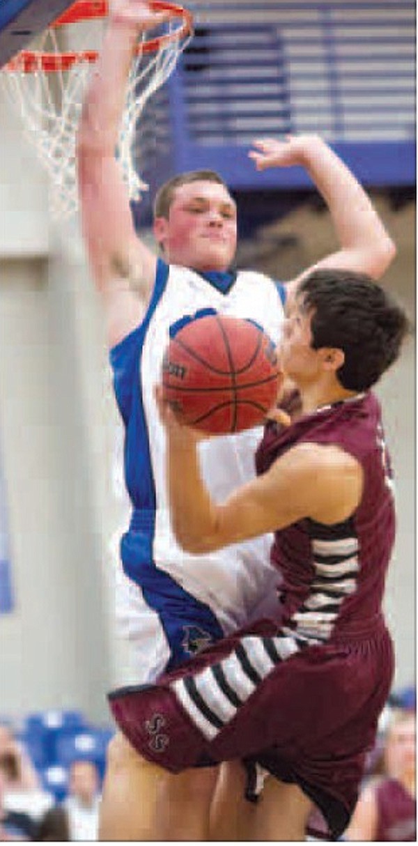 Raul Leyva, right, of Siloam Springs goes up for the shot as Brett Gentz of Rogers goes up to block the shot at Rogers on Tuesday. 