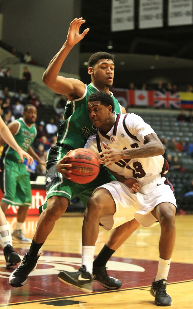 UALR’s Leroy Isler (right) works against North Texas’ Tony Mitchell, the Sun Belt Conference’s preseason player of the year, in the first half Thursday night at the Jack Stephens Center in Little Rock.