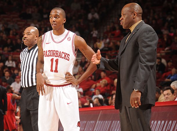 NWA Media/ANDY SHUPE -- Arkansas sophomore guard BJ Young (11) speaks with coach Mike Anderson Saturday, Jan. 5, 2013, during the second half of play against Delaware State in Bud Walton Arena in Fayetteville.