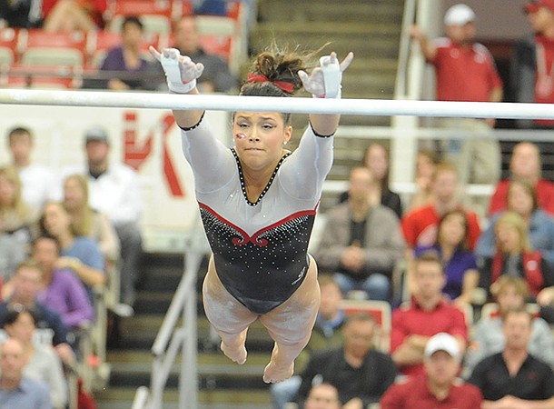 NWA Media/ANDY SHUPE -- Arkansas freshman Heather Elswick competes on the bars during a meet with Georgia Friday, Jan. 11, 2013 at Barnhill Arena in Fayetteville. 