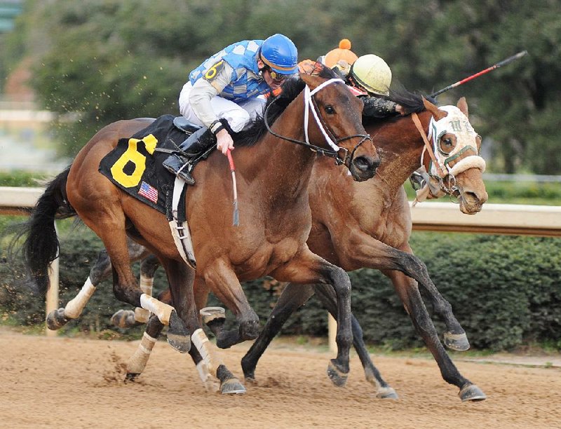 Donoharm, ridden by Clif Berry (left), edges Skyring on Friday to win The Fifth Season Stakes at Oaklawn Park. 