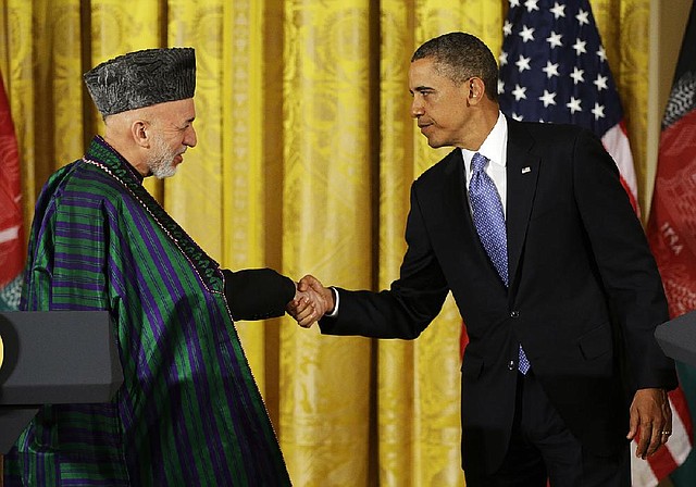 President Barack Obama and Afghan President Hamid Karzai finish off their joint news conference with a handshake Friday in the White House. 