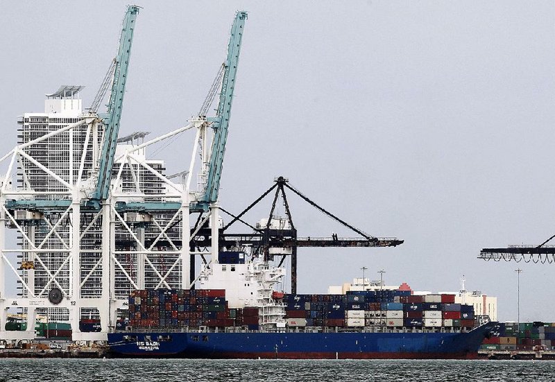 The container ship HS Bach sits docked at the Port of Miami in November, a month in which the U.S. trade deÿ cit reportedly widened 15.8 percent compared with October. 