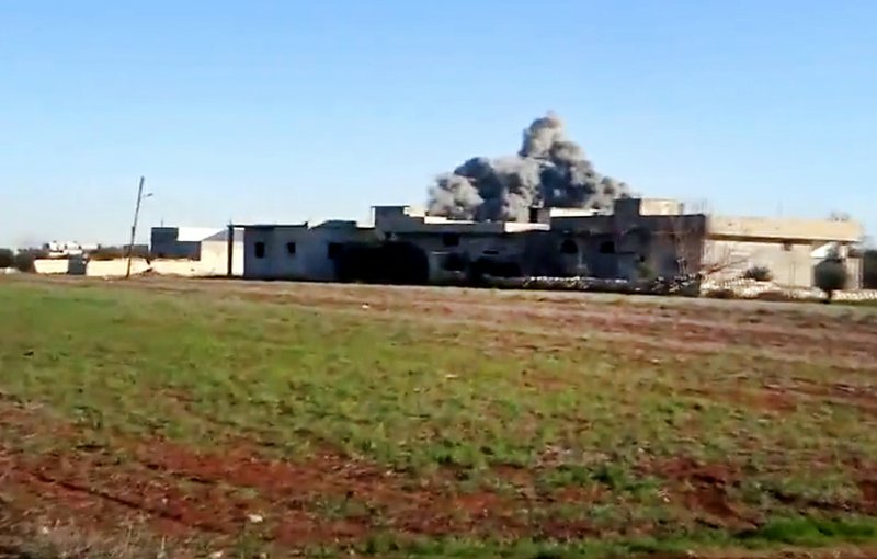 In this Thursday, Jan. 10, 2013, file image taken from video obtained from the Shaam News Network, which has been authenticated based on its contents and other AP reporting, smoke rises due to heavy shelling in Taftanaz, Idlib province, northern Syria. Syrian rebels and Islamic militants seeking to topple President Bashar Assad took full control of the Taftanaz air base Friday, Jan. 11, in a significant blow to government forces, seizing helicopters, tanks and multiple rocket launchers, activists said. 