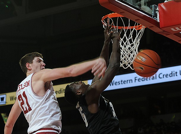 NWA MEDIA/SAMANTHA BAKER -- Arkansas' Hunter Mickelson, left, knocks the ball away from James Siakam of Vanderbilt Saturday, Jan. 12, 2013, during the second half at Bud Walton Arena in Fayetteville.