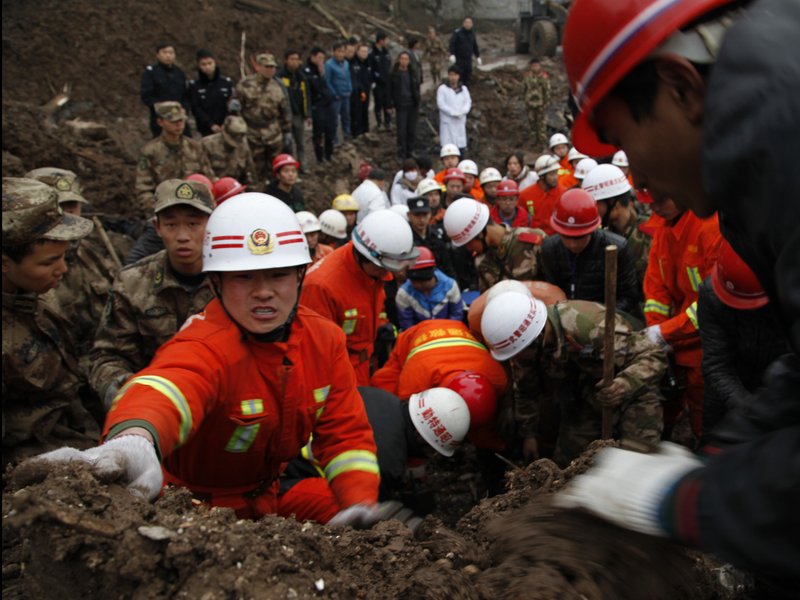 n this Jan. 11, 2013 photo provided by China's Xinhua News Agency, rescuers work at the mud-inundated debris after a landslide hit Zhaojiagou in Zhenxiong County, southwest China's Yunnan Province. A landslide swept through the village in the steep, snow-dusted mountains of southern China on Friday, killing at least 32 people, the local government said.