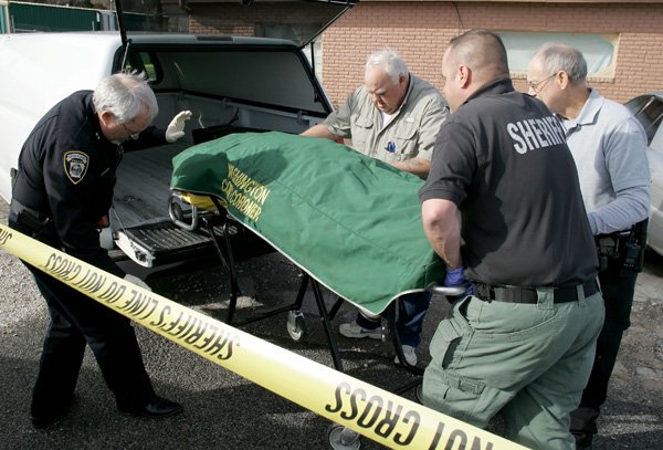 Greenland Police Chief Gary G. Ricker, left, helps Washington County personnel load the body of Betty DeSalvo at 1037 North Main in Greenland, the site of a double homicide Thursday night. Police released the names of two women killed and the man arrested in connection with their deaths. Mandrake Patterson was arrested in connection with the shooting deaths of his wife, Hope Patterson, and her mother, Betty DeSalvo, Ricker said. For video, go to nwaononline.com. 
