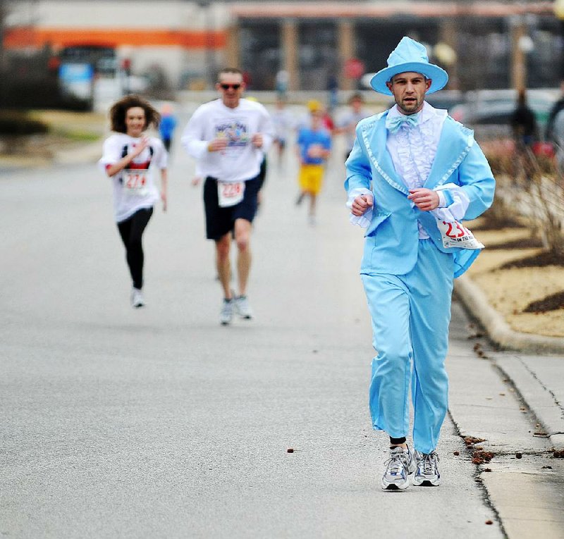 David Steeves of Rogers approaches the finish line dressed in his blue tux during the 2013 Tux on the Run 5K race at the Northwest Arkansas Mercy Family YMCA in Rogers. The 2014 race is slated for Jan. 18. 