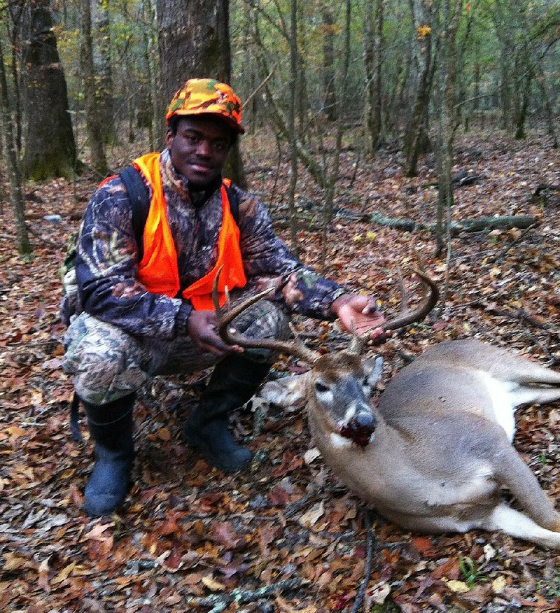 Deion Tidwell’s (upper right) first deer was an 8-point buck with a 21-inch spread.