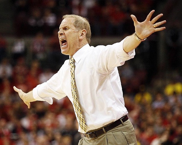 Michigan Coach John Beilein tries to get the attention of his team during the first half Sunday against Ohio State in Columbus, Ohio. 