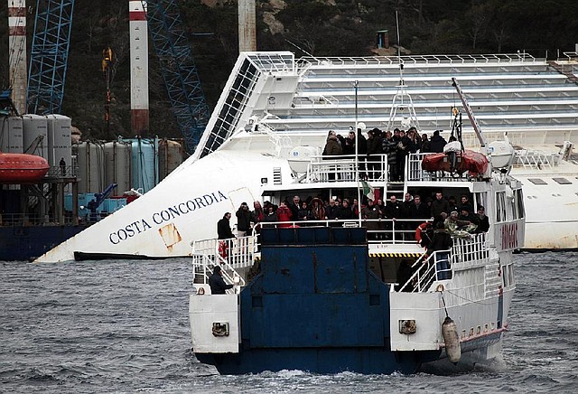 Relatives of the 32 victims of the Costa Concordia grounding approach the shipwreck aboard a ferry Sunday off the Tuscan island of Giglio, Italy.