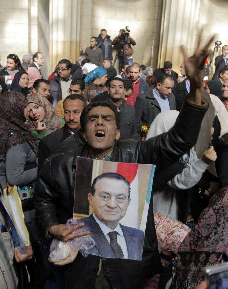 Egyptian supporters of ousted former President Hosni Mubarak celebrate after an appeal of Mubarak’s life sentence was granted by a court in Cairo on Sunday. 