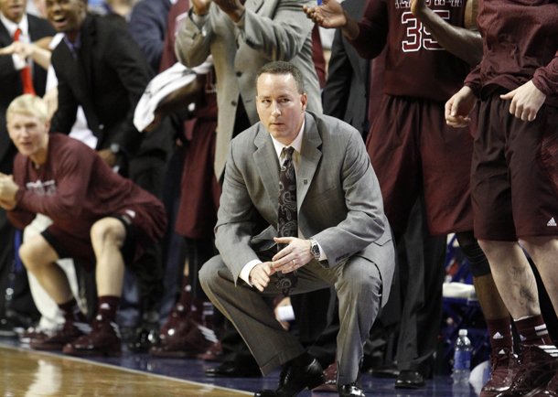 Texas A&M head coach Billy Kennedy, bottom center, watches the closing moments while the bench celebrates behind him late in the second half of an NCAA college basketball game against Kentucky at Rupp Arena in Lexington, Ky., Saturday, Jan. 12, 2013. Texas A&M won 83-71. (AP Photo/James Crisp)