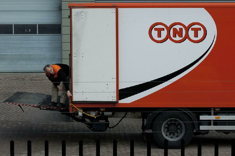A TNT Express NV employee operates the lift on a delivery truck in Hoofddorp, near Amsterdam, Netherlands, in this file photo. UPS has ditched its bid to take over TNT after learning European regulators would reject the deal. 