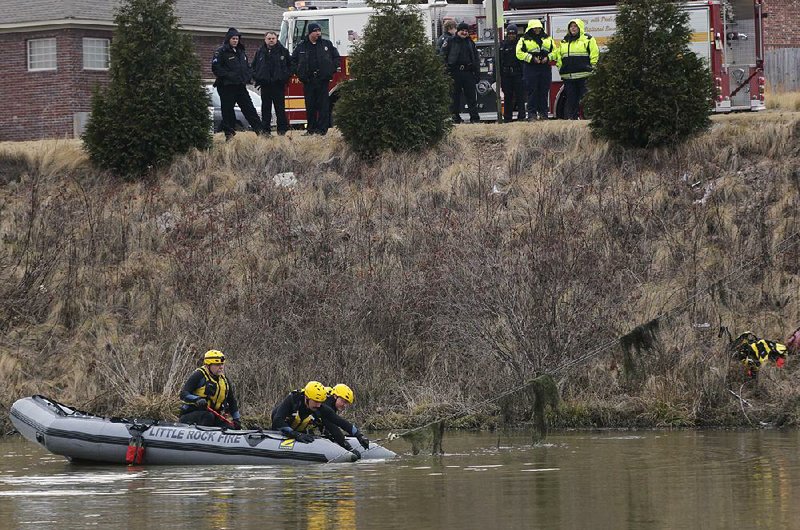 FILE — Little Rock firefighters recover a vehicle submerged in a lake at Cooper Orbit Rd. and Rushmore Rd. on Jan. 14, 2013.