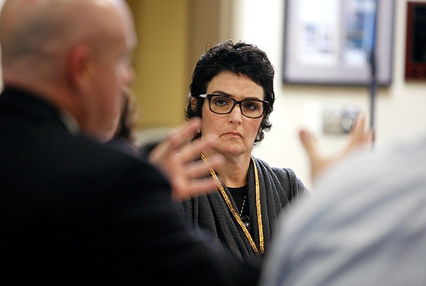 Wendi Cheatham, Bentonville School Board member, listens as Michael Poore, left, Bentonville Public Schools superintendent, speaks Monday during a meeting with board members on recent survey results regarding millage increase options at the administration building in Bentonville. 