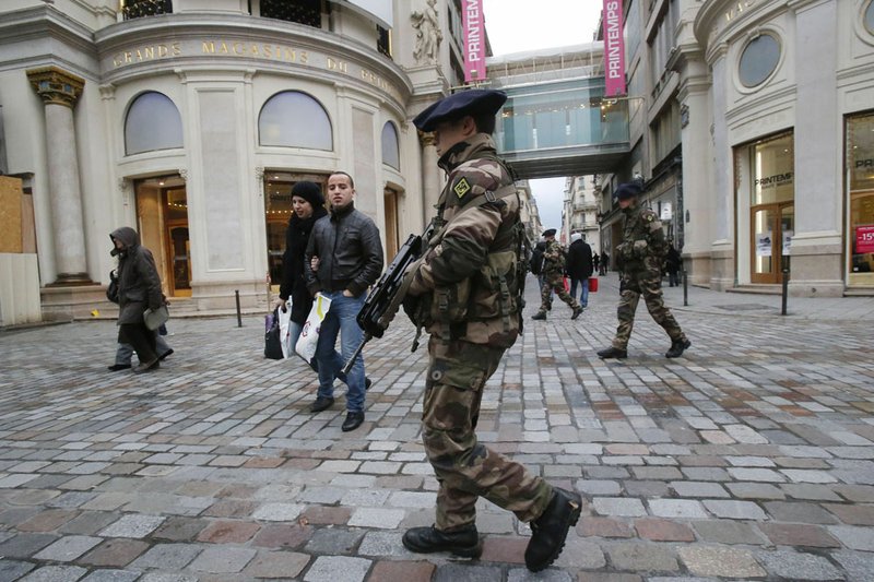 French army soldiers patrol along a main department store in Paris, Tuesday Jan. 15, 2013. Armed soldiers are on patrol in Paris' subways, train stations and some of the world's most recognizable monuments to head off terror attacks after France's military launched an operation to push back al-Qaida-linked insurgents in Mali.