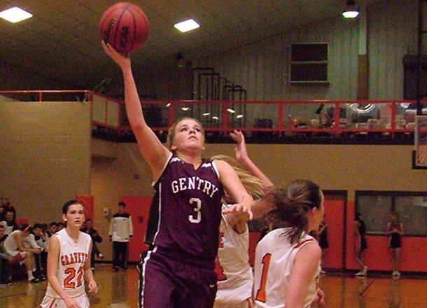 Photo by Randy Moll -- Gentry senior guard Tara Arnold attempts a shot over Gravette senior Destaney Wishon during play in Gravette on Tuesday night.