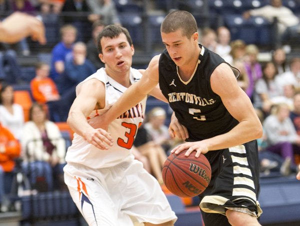 Nick Smith, right, of Bentonville goes up for the shot Friday against Rogers Heritage defender Luke Fryauf at Rogers Heritage. Smith finished with 25 points and 16 rebounds. 