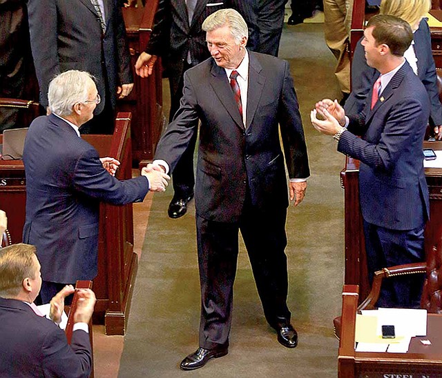 Gov. Mike Beebe greets House members Tuesday as he works his way down the aisle to give his address to a joint session of the Legislature. 