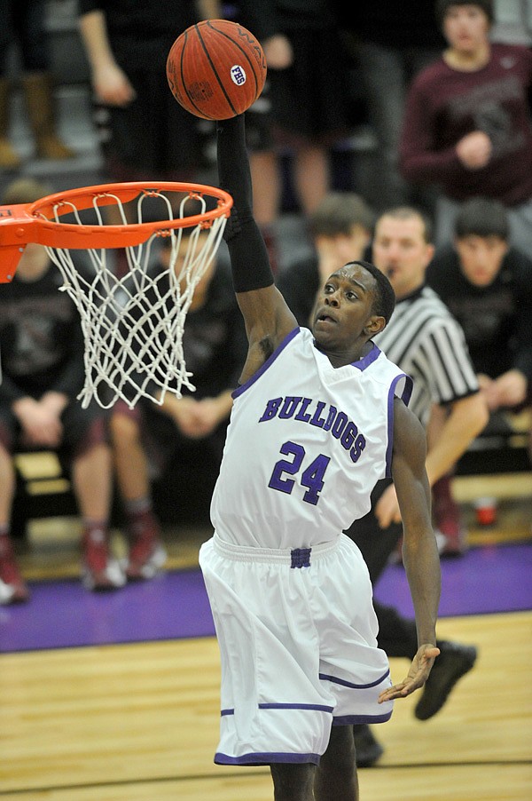 Jawan Smith of Fayetteville goes up for a dunk on a fast break against Siloam Springs on Tuesday at Fayetteville. 