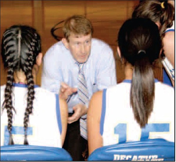Decatur Coach Bill Niven speaks with his players courtside during a game. Niven, Decatur girls’ basketball coach, came out of retirement to take over the Lady Bulldogs’ program this year. This is his first season to coach girls’ basketball. Niven won a state championship at Hope in 1986. 