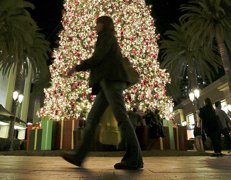 A shopper passes a Christmas tree at the Fashion Island shopping center in Newport Beach, Calif., in December. Retail sales rose 0.5 percent in December compared with November, the Commerce Department said Tuesday. 