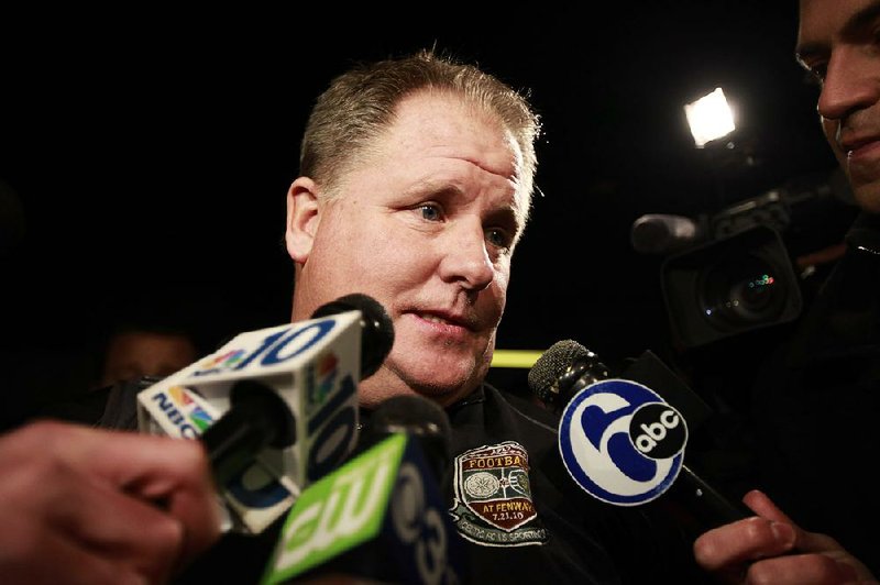 Chip Kelly speaks to members of the media as he arrives at Northeast Philadelphia Airport, Wednesday, Jan. 16, 2013, in Philadelphia. Oregon's enigmatic NCAA college football head coach of four years surprised the school with an early morning phone call Wednesday to say he was leaving to become head coach of the Philadelphia Eagles NFL football team, just a little more than a week after he told Oregon he was staying. (AP Photo/The Philadelphia Inquirer, David Swanson)  PHIX OUT; TV OUT; MAGS OUT; NEWARK OUT