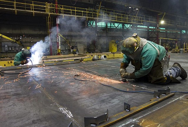 Welders work on sides for refrigerated railcars at the Greenbrier Cos.' Gunderson railcar plant in Portland, Oregon, U.S., on Tuesday, Jan. 15, 2013. Industrial production in the U.S. climbed for a second month in December as demand picked up for capital equipment, showing factories strengthened entering 2013. Photographer: Natalie Behring/Bloomberg