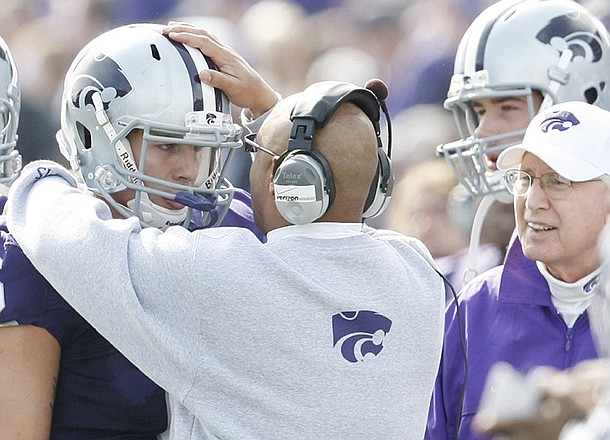 Wide receivers coach Michael Smith talks with Kansas State quarterback Grant Gregory on the sideline during a 2009 game against Colorado. 