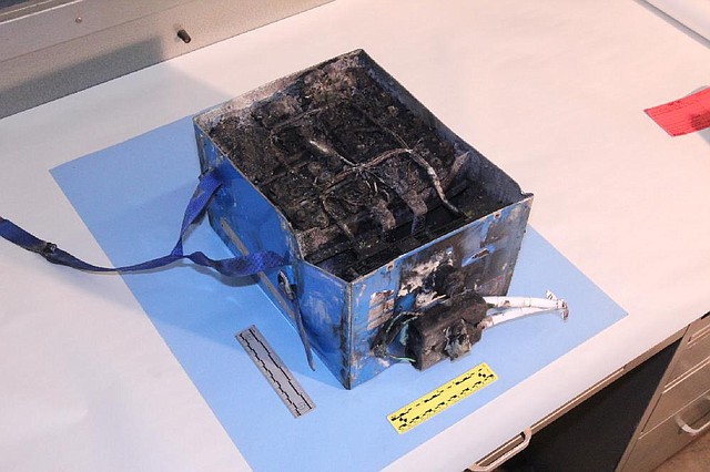 The National Transportation Safety Board displays the burned auxiliary power unit battery from a Japan Air Lines Boeing 787 in this undated photo. The battery caught ÿre while the plane was parked at Boston’s Logan International Airport on Jan. 7. 