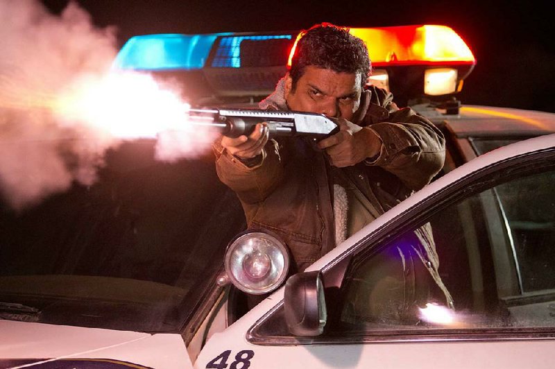 Deputy Mike Figuerola (Luis Guzman) scatters buckshot in the cause of righteousness in The Last Stand. 