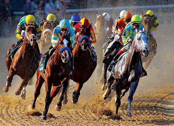 Horses race through the turn during the ÿrst race Thursday at Oaklawn Park in Hot Springs. It was the ÿrst racing on the track since opening day Friday after inclement weather damaged the racing surface and canceled live racing Saturday and Sunday. 