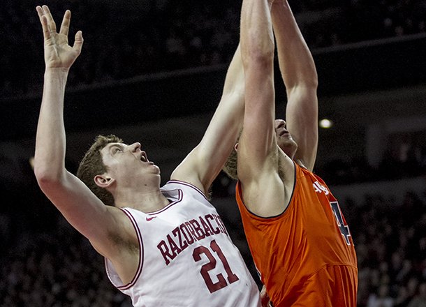Arkansas' Hunter Mickelson (21) attempts to rebound against Auburn's Rob Chubb (41) during the second half an NCAA college basketball game in Fayetteville, Ark., Wednesday, Jan. 16, 2013. Arkansas defeated Auburn 88-80. (AP Photo/Gareth Patterson)