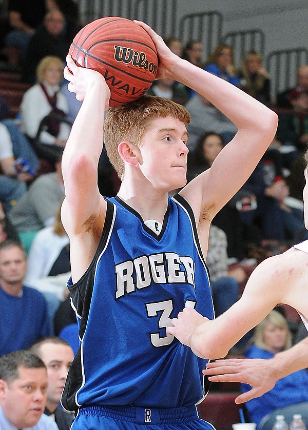 Jake Killingsworth of Rogers looks for an open teammate during the second half of the game against Springdale on Jan. 4 at Springdale. 