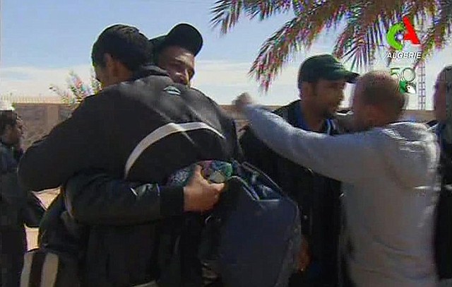 Rescued hostages hug each other in Ain Amenas, Algeria, in this image taken from television Friday, Jan. 18, 2013. 