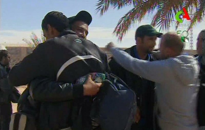 Rescued hostages hug each other in Ain Amenas, Algeria, in this image taken from television Friday, Jan. 18, 2013. 