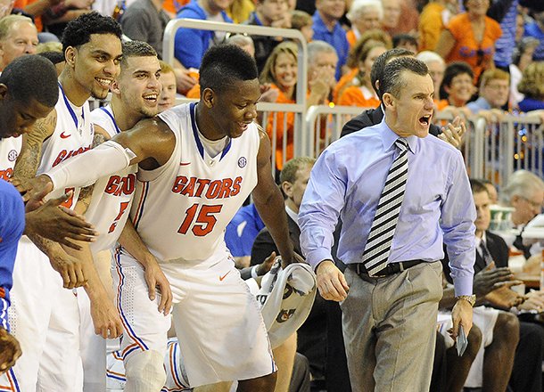 Florida coach Billy Donovan, right, shouts to his team as the clock runs down during the second half against Missouri, as his bench celebrates during an NCAA college basketball game in Gainesville, Fla., Saturday, Jan. 19, 2013. Florida won 83-52. It was Donovan's 400th career coaching win at Florida. (AP Photo/Phil Sandlin)