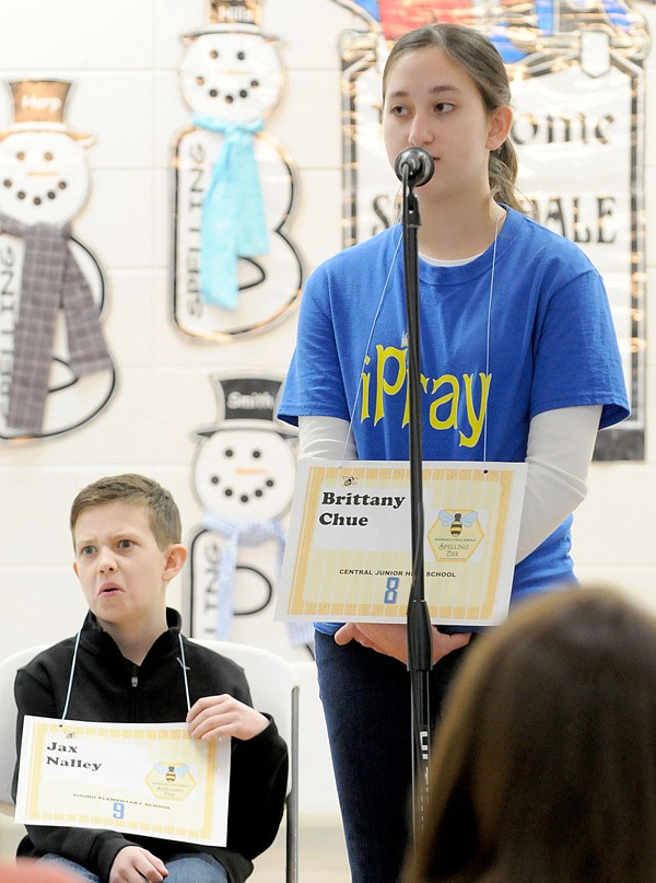 Jax Nally, left, of Young Elementary School reacts Friday as Central Junior High School’s Brittany Chue spells the championship word correctly during the Springdale School District spelling bee at Parson Hills Elementary School. Jax was the first runner-up with Helen Tyson Middle School’s Sojas Wagle as the second runner-up. 